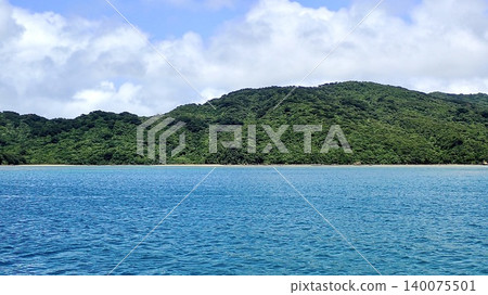 Subtropical mountains and the blue sea stretch across the secluded Oku-Iriomote Island. Subtropical mountains and the blue sea stretch across the secluded Oku-Iriomote Island. 140075501