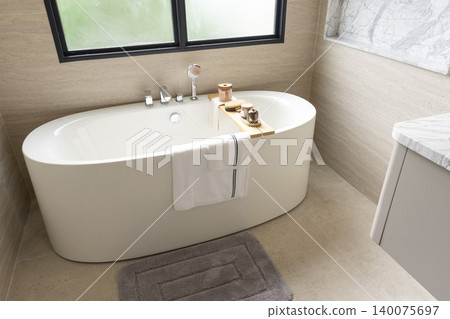 Beautiful luxury bathroom with large white tub and white tile walk in shower. Beautiful luxury bathroom with large white tub and white tile walk in shower. 140075697