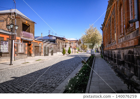 Quiet historic street with cobblestones and old architecture under sunny sky Quiet historic street with cobblestones and old architecture under sunny sky 140076259