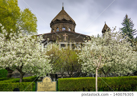 Old stone church surrounded by blooming white trees Old stone church surrounded by blooming white trees 140076305