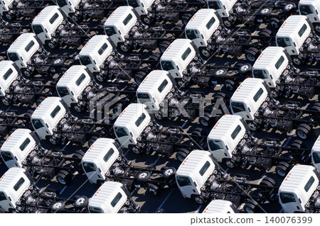 An overhead view of trailer trucks lined up in a regular pattern. An overhead view of trailer trucks lined up in a regular pattern. 140076399