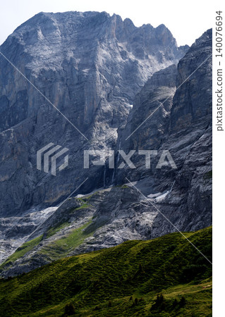 The massive rock faces and detailed rock surfaces of Switzerland, and the green mountain slopes. The massive rock faces and detailed rock surfaces of Switzerland, and the green mountain slopes. 140076694