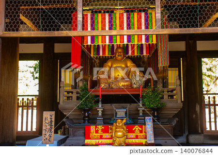 The blessings of the benevolent seated statue of Hotei at Manpuku-ji Temple: business prosperity, good fortune, academic success, and good health and longevity. 140076844