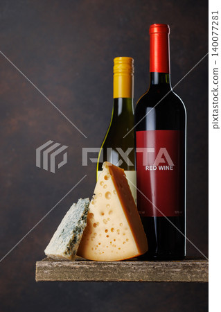 Red and white wine with cheese on wooden table Red and white wine with cheese on wooden table 140077281