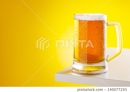 Beer mug with foam yellow background snack setup 140077293