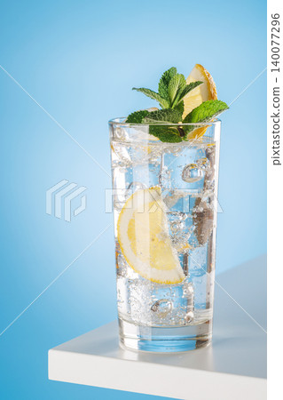 Sparkling water with lemon and mint on blue background fresh drink Sparkling water with lemon and mint on blue background fresh drink 140077296