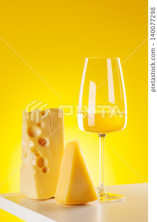 Glass of white wine with cheese on yellow background food pairing concept Glass of white wine with cheese on yellow background food pairing concept 140077298