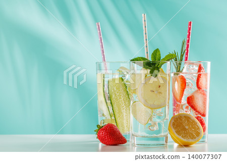 Set of fresh non alcoholic drinks with strawberry cucumber and lemon on blue background Set of fresh non alcoholic drinks with strawberry cucumber and lemon on blue background 140077307