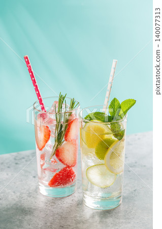 Two fresh non alcoholic drinks with strawberry and lemon on blue background Two fresh non alcoholic drinks with strawberry and lemon on blue background 140077313