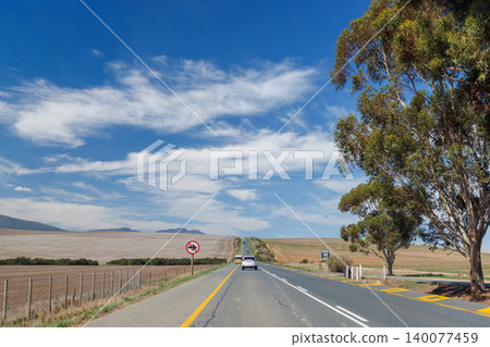 Asphalt road in South Africa surrounded by fields Asphalt road in South Africa surrounded by fields 140077459