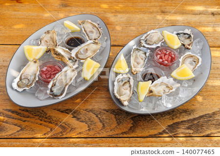 Fresh oysters on ice with champagne Fresh oysters on ice with champagne 140077465