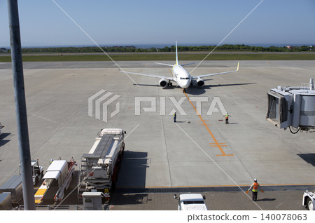 An airplane arriving at Hakodate Airport with a blue sky and sea as its backdrop. An airplane arriving at Hakodate Airport with a blue sky and sea as its backdrop. 140078063