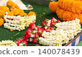 Assorted flower garlands made of jasmine, roses, and marigolds for religious offerings 140078439
