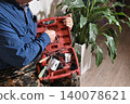 using electric drilling on wooden board 140078621
