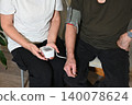 Elderly man measures blood pressure of elderly woman at home 140078624