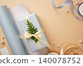 Gift box wrapped in light blue polka dot paper with cream satin bow and green fir sprig. Space for text 140078752