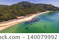 Aerial view of the crystal-clear emerald green sea and the rocky reefs of Diamond Long Beach. 140079992