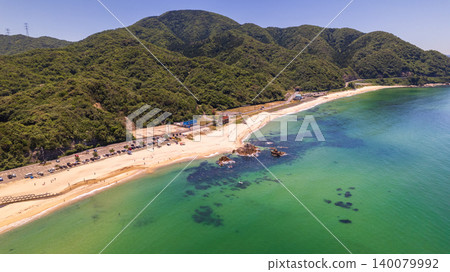 Aerial view of the crystal-clear emerald green sea and the rocky reefs of Diamond Long Beach. Aerial view of the crystal-clear emerald green sea and the rocky reefs of Diamond Long Beach. 140079992