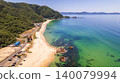 A coastal road running along the emerald green sea and a white sand beach (Mihama Town, Fukui Prefecture) 140079994