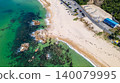 [Top View] Drone footage of the crystal-clear waters and rocky reefs at Diamond Long Beach in Mihama Town. 140079995