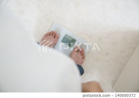 Barefoot on the weighing scale Barefoot on the weighing scale 140080372