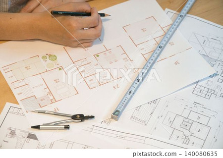 Hands and building tools for checking design drawings Hands and building tools for checking design drawings 140080635