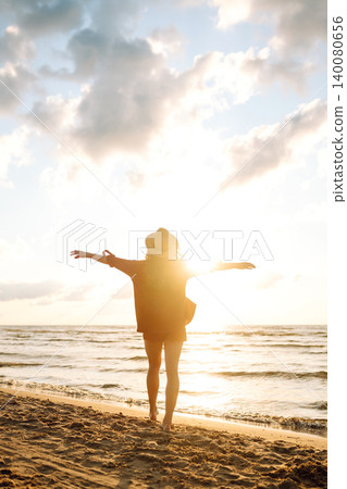 Beautiful woman enjoying a summer day on the beach at sunset. Lifestyle, tourism, active life. Beautiful woman enjoying a summer day on the beach at sunset. Lifestyle, tourism, active life. 140080656
