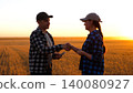 farmer makes deal to buy farmland. handshake of farmers them as a symbol of the deal of purchase and sale. purchase and sale of farmland 140080927