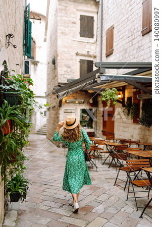 Young beautiful woman in trendy summer dress posing in street. Fashion style. Tourist attraction. 140080997