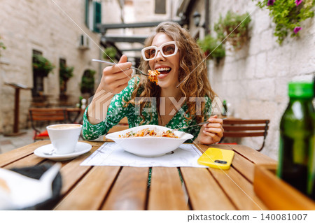 Woman eating italian pasta and drinking coffee at restaurant on the street in Rome. Food and drink. Woman eating italian pasta and drinking coffee at restaurant on the street in Rome. Food and drink. 140081007