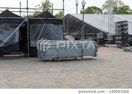 Metal scaffolding pipes stacked on a rack for stage construction Metal scaffolding pipes stacked on a rack for stage construction 140081068