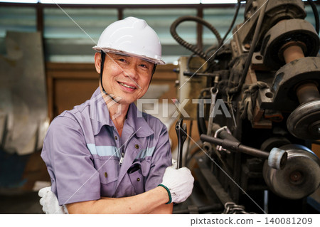 Portrait of smiling male engineer with industrial tool Portrait of smiling male engineer with industrial tool 140081209