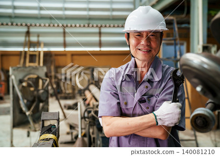 Portrait of smiling male engineer with industrial tool Portrait of smiling male engineer with industrial tool 140081210