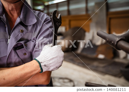Portrait of smiling male engineer with industrial tool Portrait of smiling male engineer with industrial tool 140081211