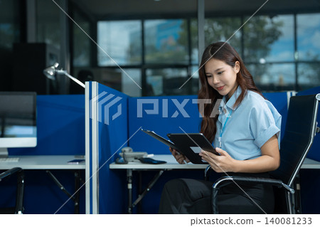 Send a message to a colleague, a businessman, confident in matching a tablet and sitting in office. Send a message to a colleague, a businessman, confident in matching a tablet and sitting in office. 140081233