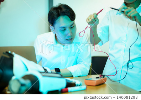 Asian university students working on robotics STEM project in lab 140081298