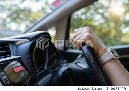 Close up of driver hands on steering wheel with smart watch in car Close up of driver hands on steering wheel with smart watch in car 140081429