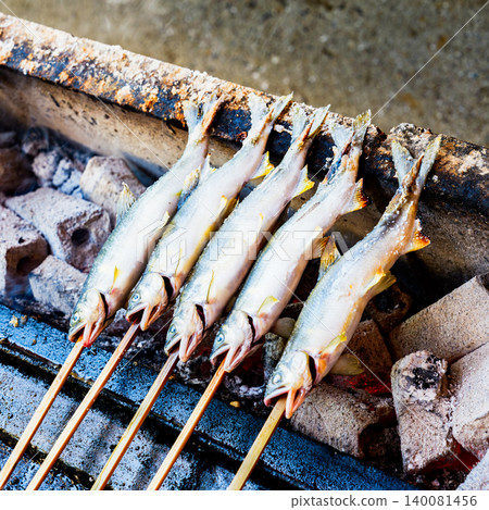 Grilled sweetfish (ayu) on skewers and seasoned with salt. 140081456