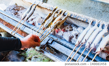 Grilled sweetfish (ayu) on skewers and seasoned with salt. Grilled sweetfish (ayu) on skewers and seasoned with salt. 140081458