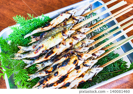 Grilled sweetfish (ayu) on skewers and seasoned with salt. Grilled sweetfish (ayu) on skewers and seasoned with salt. 140081460
