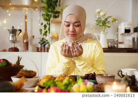 Muslim Woman Praying Before Iftar Meal During Ramadan at Home Muslim Woman Praying Before Iftar Meal During Ramadan at Home 140081613