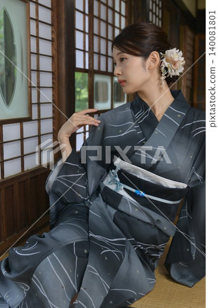 A young woman in a yukata A young woman in a yukata 140081801