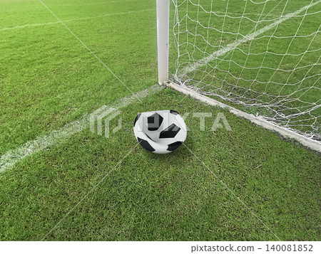 Deflated soccer ball on green grass field near the goal post, failure or missed opportunity concept Deflated soccer ball on green grass field near the goal post, failure or missed opportunity concept 140081852