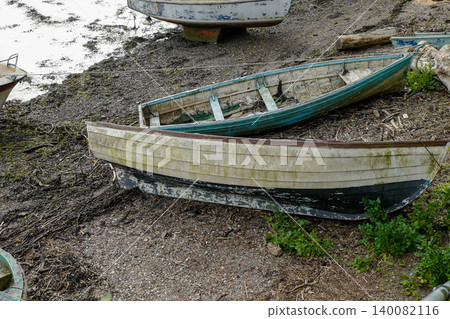 Old boats on the shore line in various state of decay Old boats on the shore line in various state of decay 140082116