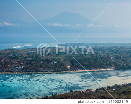 Volcanic island landscape with coastline and volcano mountain in tropical haze Volcanic island landscape with coastline and volcano mountain in tropical haze 140082149