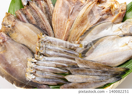 A wide selection of dried fish and white fish, and fresh seafood served on green leaves. A wide selection of dried fish and white fish, and fresh seafood served on green leaves. 140082251