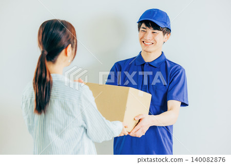 A courier driver delivering a package 140082876