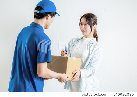 A woman signing a shipping label for her package. A woman signing a shipping label for her package. 140082880