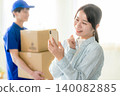 Courier woman delivering luggage 140082885