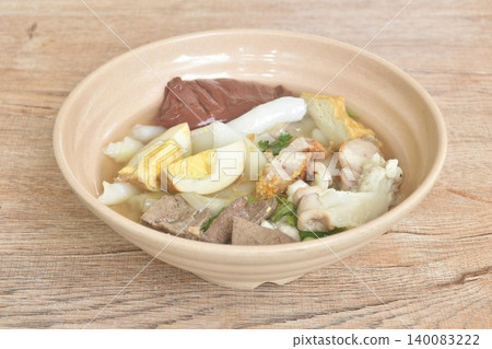 large rice noodles chop and crispy pork couple organ topping egg in clear blood soup on bowl large rice noodles chop and crispy pork couple organ topping egg in clear blood soup on bowl 140083222